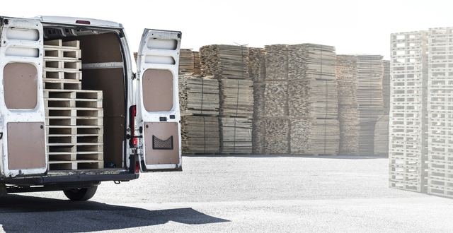 Een bestelwagen geladen met houten paletten